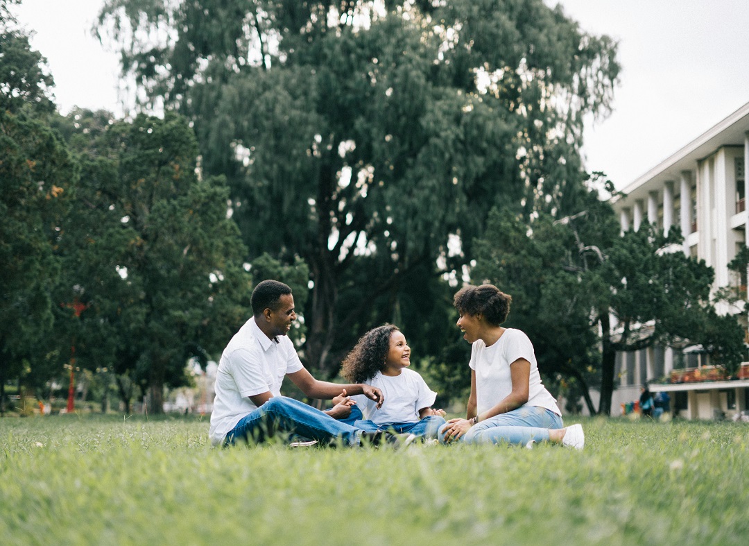 Man and woman play with their daughter on the field. PHOTO CREDITS: Pexels.com