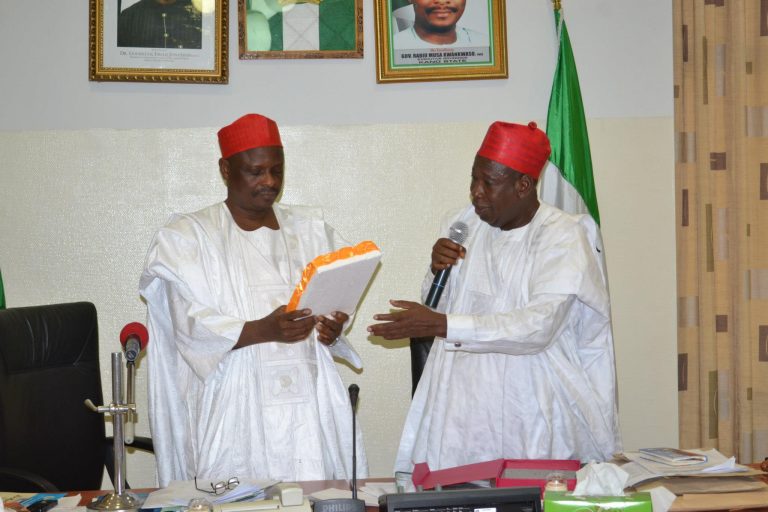 The original photo showing the then Deputy Governor of Kano State, Dr. Abdullahi Umar Ganduje, presenting a plaque in honour of His Excellency, the then Governor Rabiu Musa Kwankwaso of Kano State awarded to him by the National Air Traffic Communicators Institute of Nigeria in Abuja in September 2012. Kwankwaso was represented at the event by his then deputy. PHOTO CREDITS: Kano State Government.